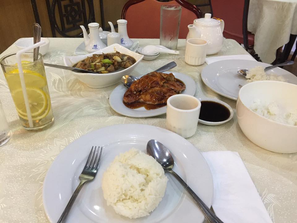 Dining table spread at President Grand Palace with duck beef brisket rice lemonade and tea
