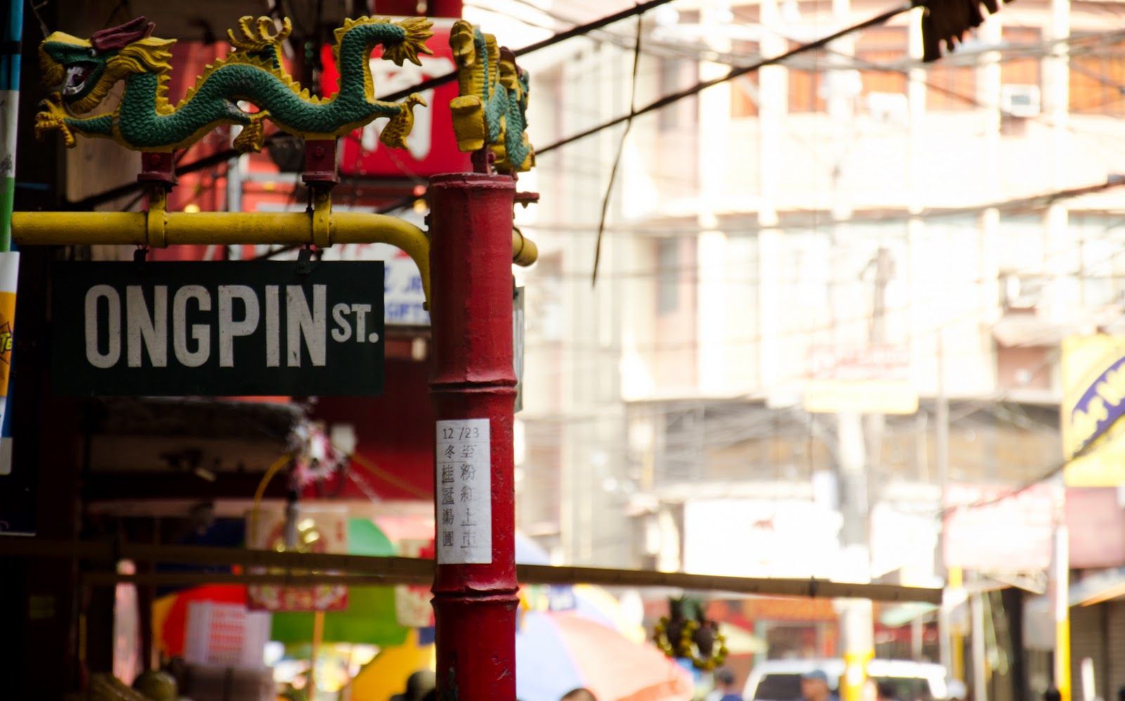 Ongpin Street sign in Binondo Manila with dragon decorations near President Grand Palace